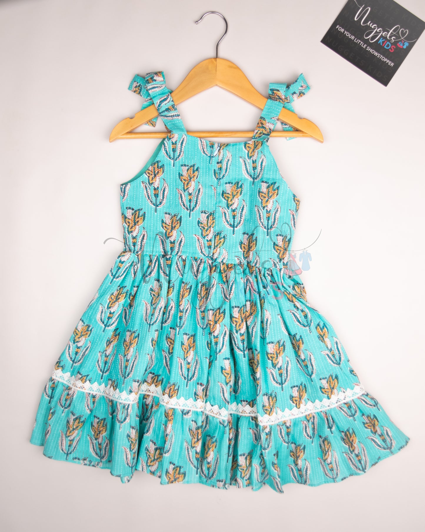 Ready to Ship: Turquoise Blue Kantha Sleeveless Frock with multilayered lace detailing in the yoke and flare, and attached bows in the shoulder strap