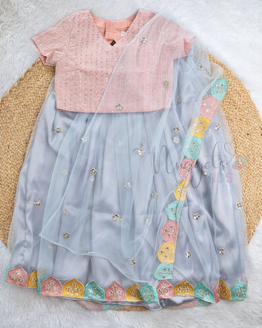 Pre Order: Dusky Pink Top And Ice Blue Lehenga Set