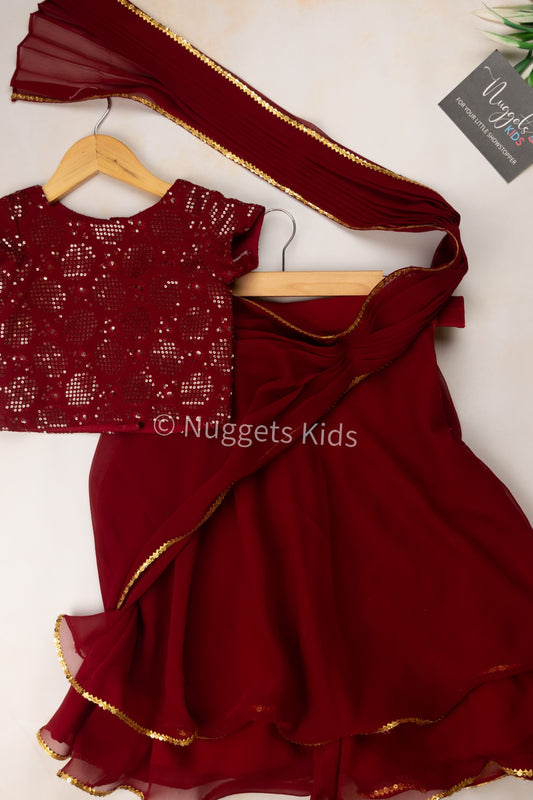 Pre Order: Maroon georgette double layer skirt with attached pleated dupatta with a crop top and a tie back belt