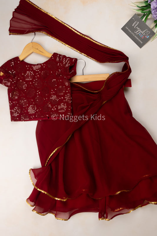Pre Order: Maroon georgette double layer skirt with attached pleated dupatta with a crop top and a tie back belt
