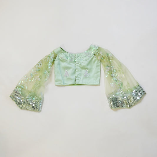 Pre Order: Pastel green sequined lehenga with halter neck top and cape style sleeves