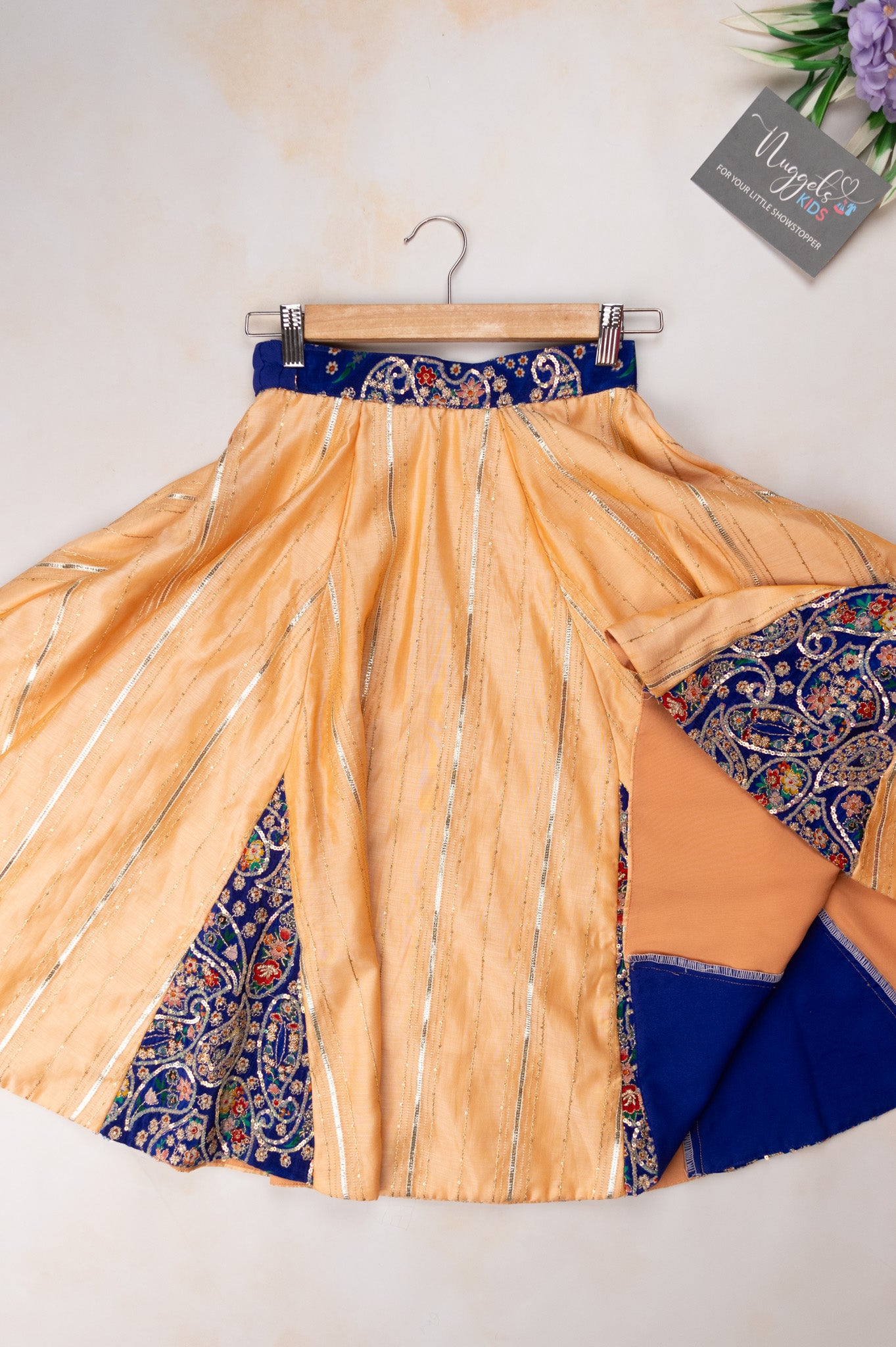 Pre Order: Beige sequined lehenga with patch work detailing and blue designer dola silk blouse with puff sleeves and sweetheart neckline