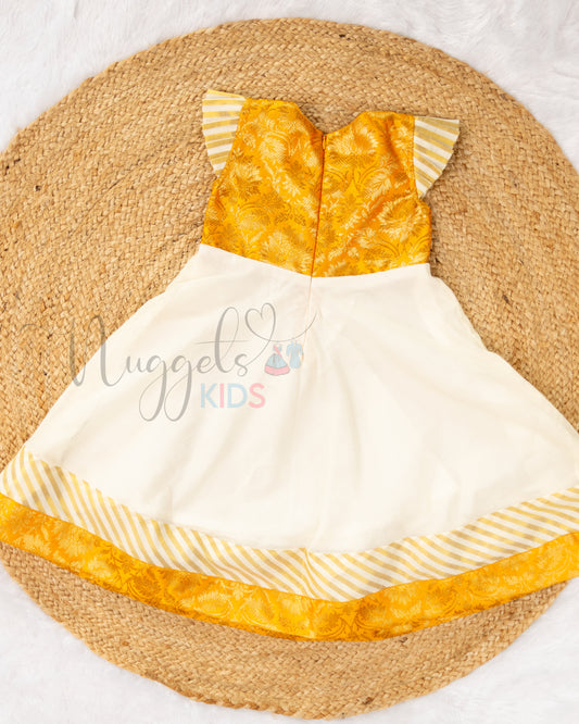 Pre Order: Stylish Kasavu Frock with v-necked Yellow Brocade yoke, pleated cap sleeves and attached double borders