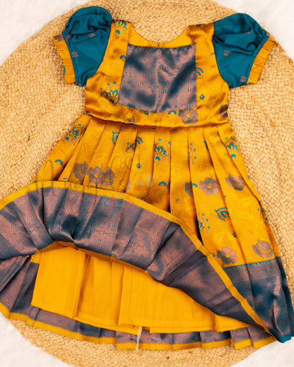 Ready to Ship: Yellow and Peacock Blue Kanchi Meenakari Semi Silk frock with patch work yoke, big zari borders and puff sleeves with pleated ends